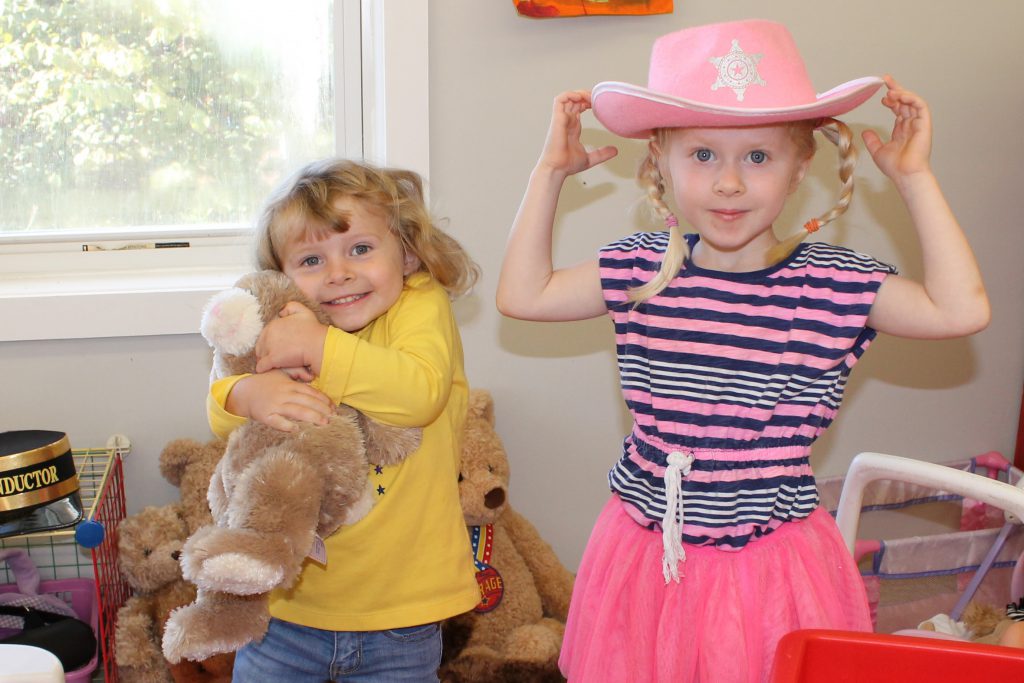Preschool students engaging in pretend play in the classroom