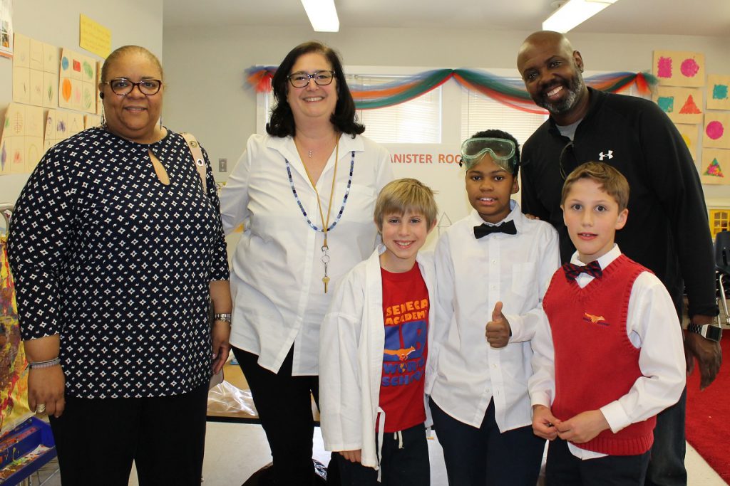 Seneca Academy Board members with elementary students at a STEAM Fair