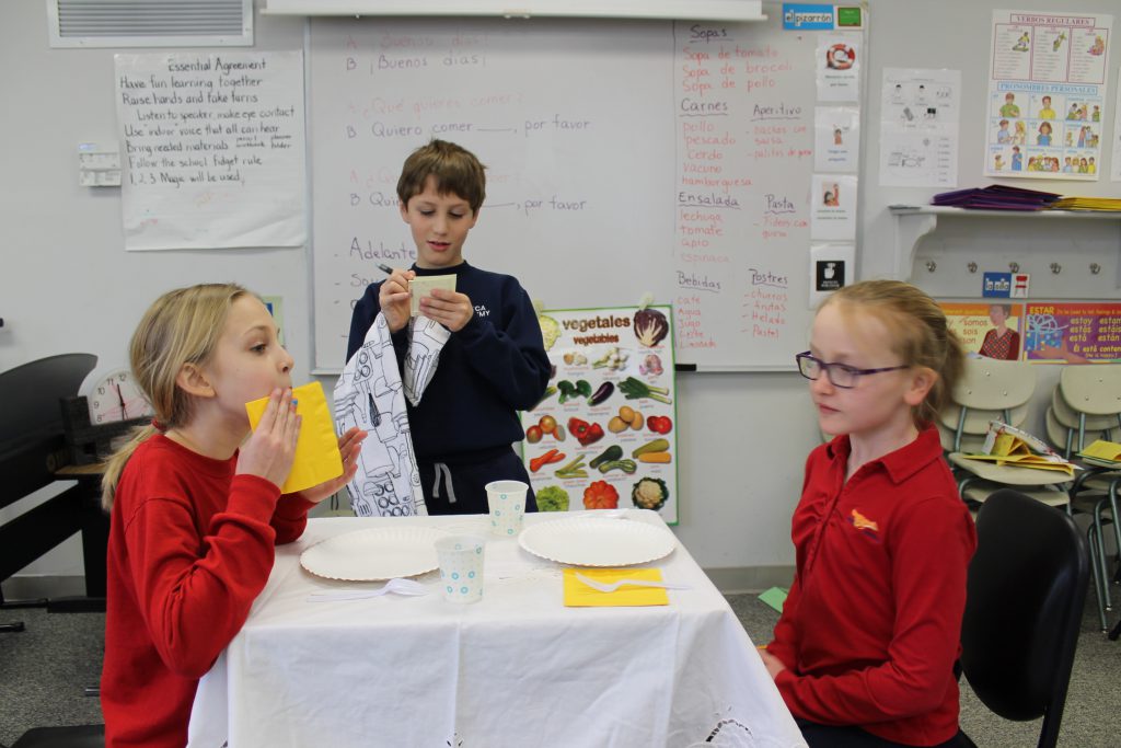 Elementary students learning about Spanish food and menus