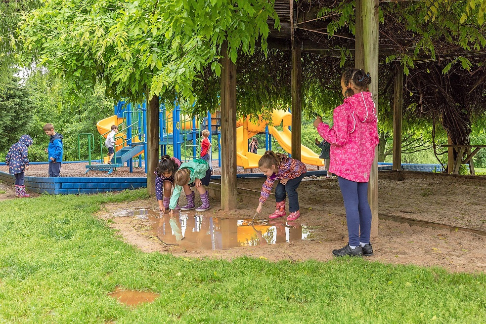 Elementary students playing outside in the rain